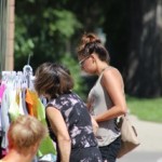 The picture of two women checking out clothes on a street